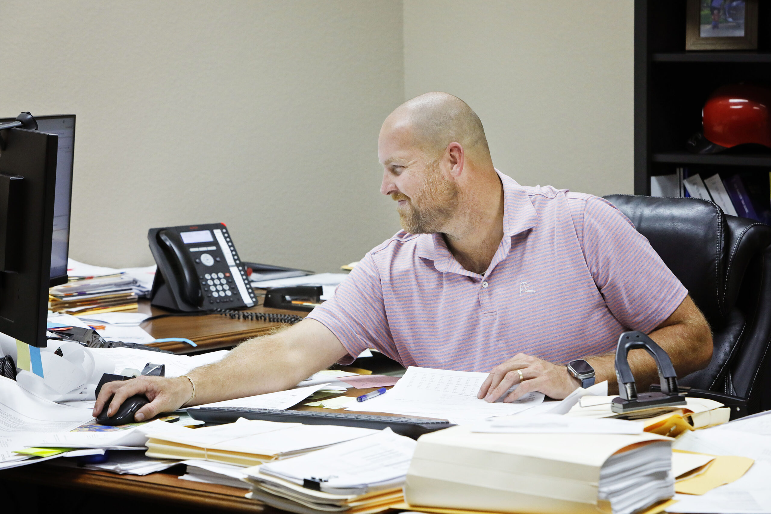 A CPA at Anderson, Marx & Bohl PC working through business tax paperwork at a desk in the firm's Corsicana, TX office