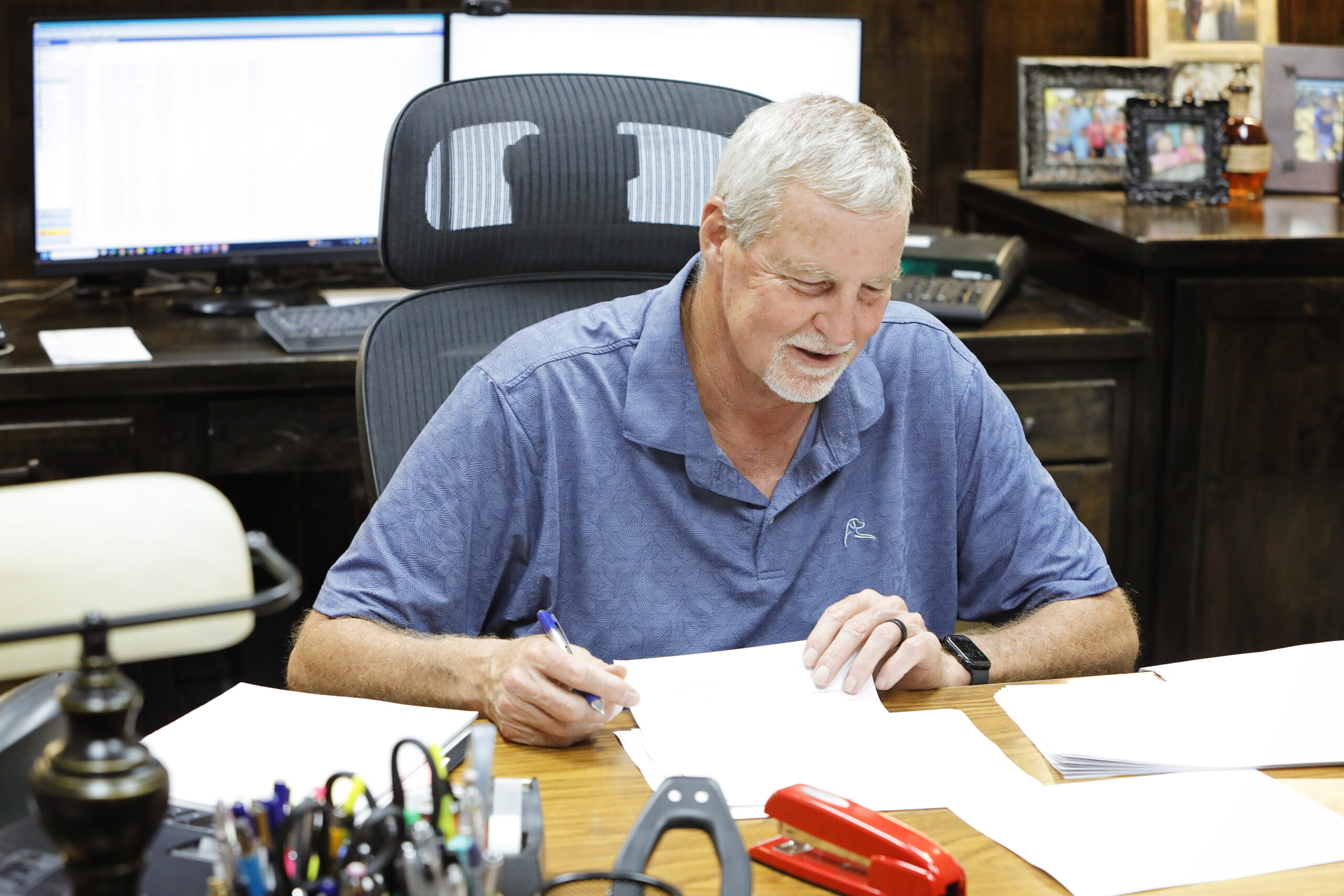 A CPA at Anderson, Marx & Bohl PC reviewing a tax document at his desk in the firm's Corsicana, TX office